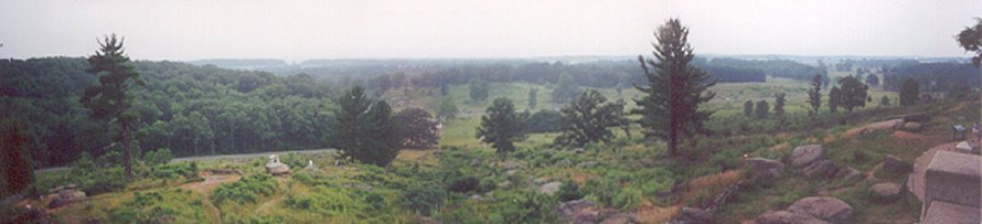 View from Little Roundtop.  Gettysburg is to the far right about two miles away.  Cemetery Ridge is visible right of the center of the image.  The boulders of Devil's Den are just to the left of center.  Big Roundtop is to the left.  